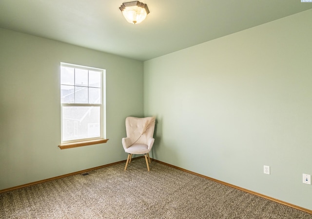 unfurnished room with carpet floors and baseboards