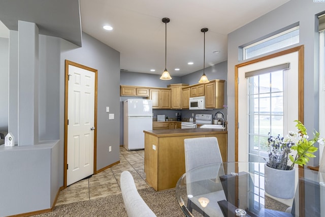 kitchen featuring white appliances, a peninsula, dark countertops, plenty of natural light, and recessed lighting