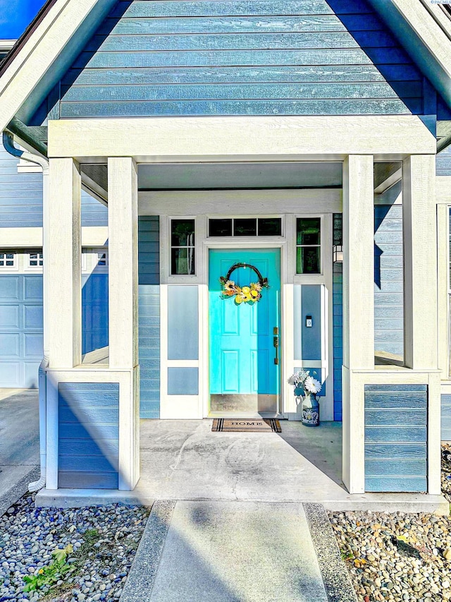 view of exterior entry featuring covered porch