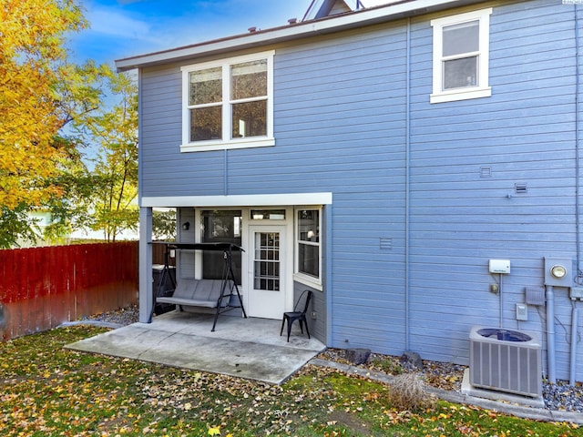 back of property featuring central air condition unit, fence, and a patio area
