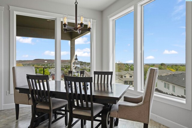 dining room with an inviting chandelier and light hardwood / wood-style floors