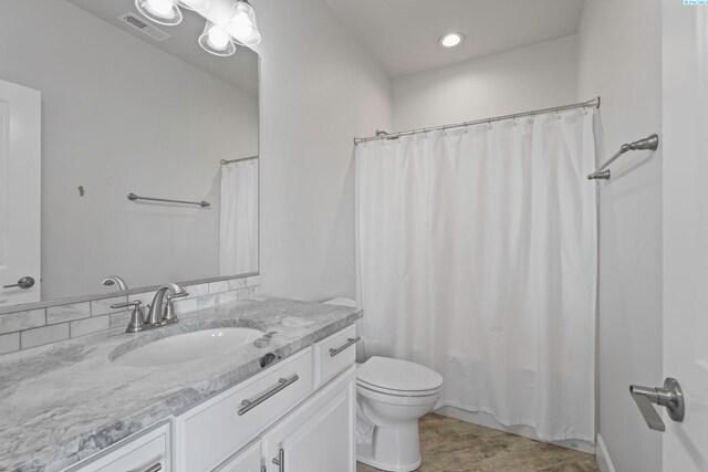 full bathroom featuring shower / bath combo with shower curtain, vanity, toilet, and wood-type flooring