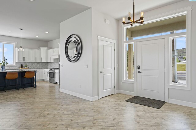 entryway featuring a notable chandelier and light wood-type flooring