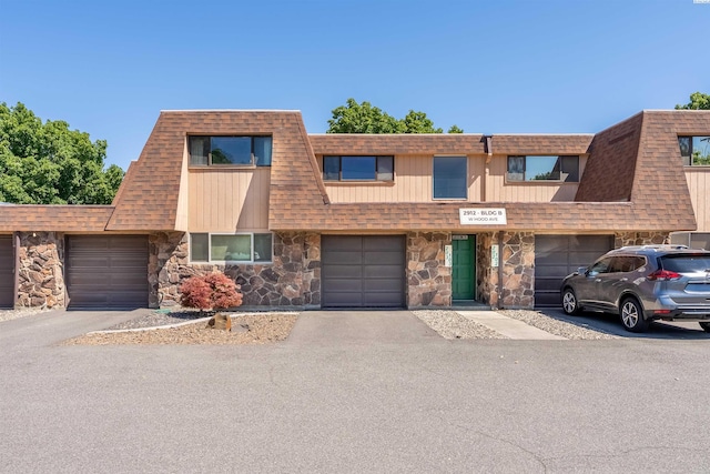 2912 W Hood Ave Unit B203, Kennewick, WA 99336 - view of front of home featuring stone siding, roof with shingles, a garage, and driveway