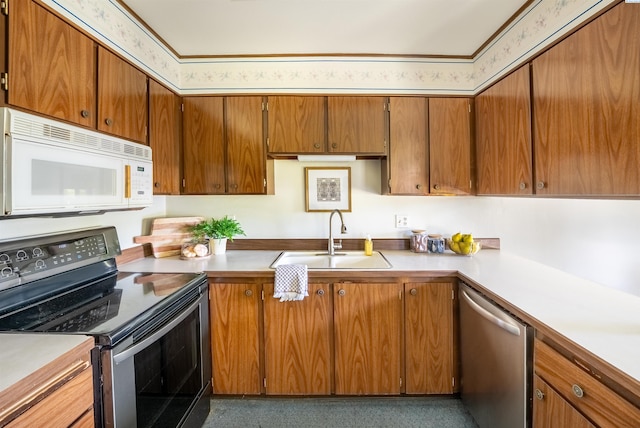 2912 W Hood Ave Unit B203, Kennewick, WA 99336 - kitchen featuring appliances with stainless steel finishes, light countertops, and brown cabinets