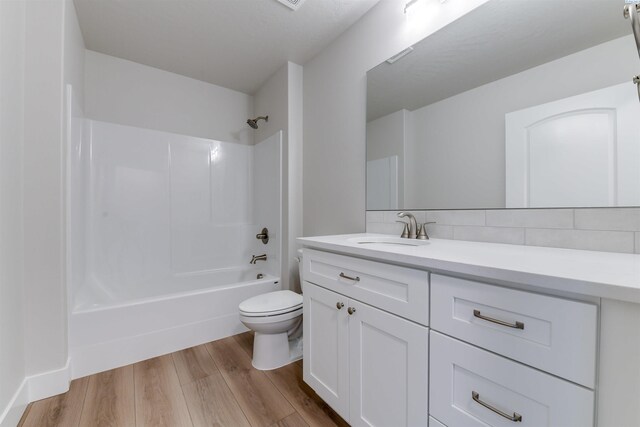 6150 W 30th Pl, Kennewick, WA 99338 - full bath with toilet, wood finished floors, vanity, shower / washtub combination, and tasteful backsplash