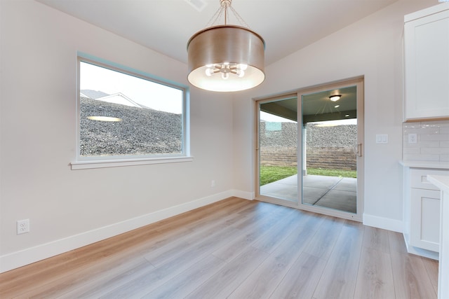6150 W 30th Pl, Kennewick, WA 99338 - unfurnished dining area featuring healthy amount of natural light, light wood-style floors, baseboards, and a chandelier