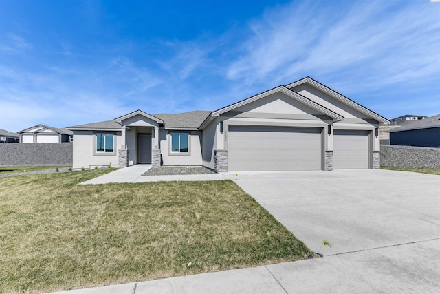 6150 W 30th Pl, Kennewick, WA 99338 - view of front of home featuring stone siding, stucco siding, an attached garage, concrete driveway, and a front yard