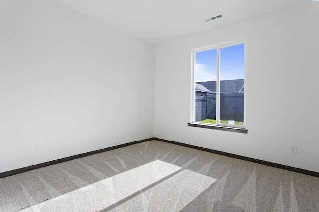 carpeted empty room with plenty of natural light