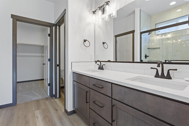 bathroom with vanity, wood-type flooring, toilet, and walk in shower