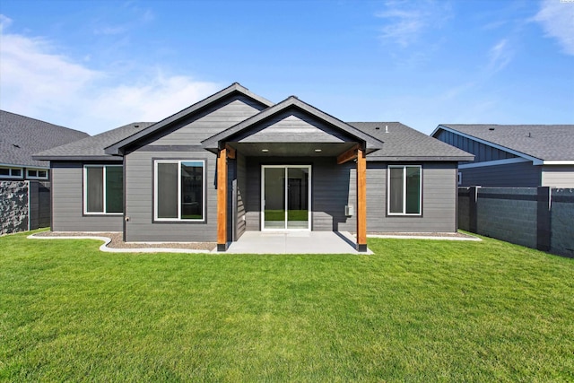 back of property featuring a yard and a patio area