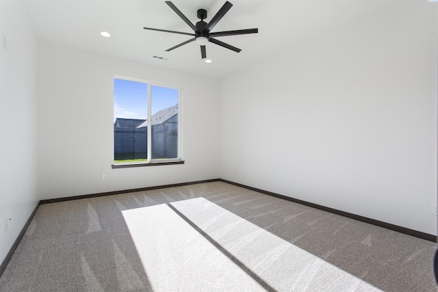 spare room with light carpet and ceiling fan