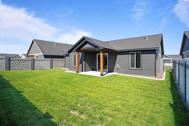 back of property featuring a lawn and a patio