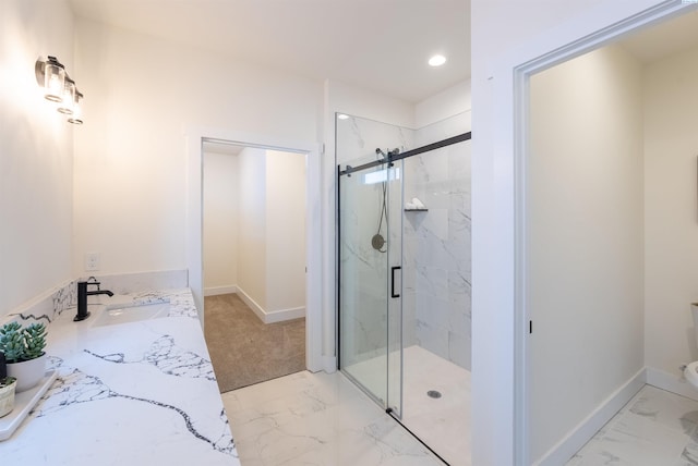 bathroom featuring vanity and an enclosed shower