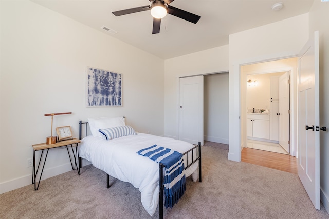 bedroom with ceiling fan, a closet, and light carpet