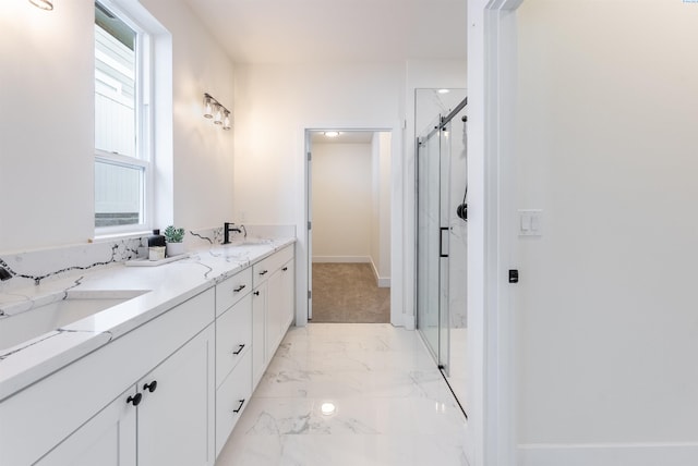 bathroom with vanity and a shower with door