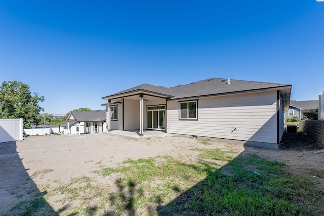 back of property with a patio