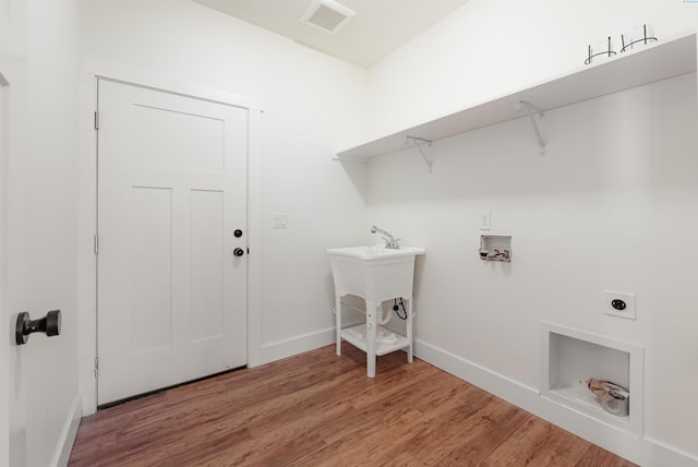 laundry area featuring washer hookup, hardwood / wood-style flooring, and hookup for an electric dryer