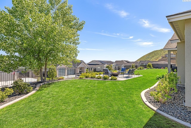 view of yard featuring a patio area and a residential view