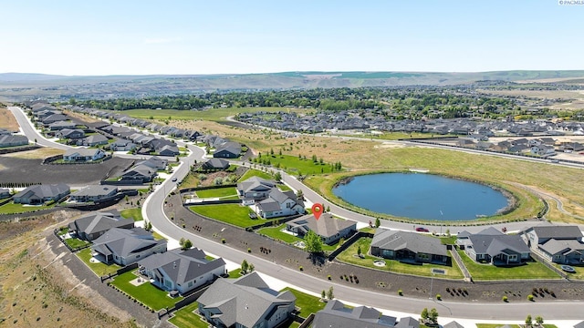 view of property location featuring a large body of water and nearby suburban area