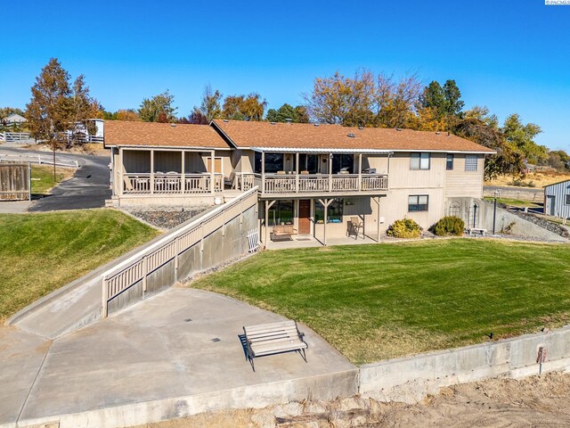 back of house with a yard and a patio area