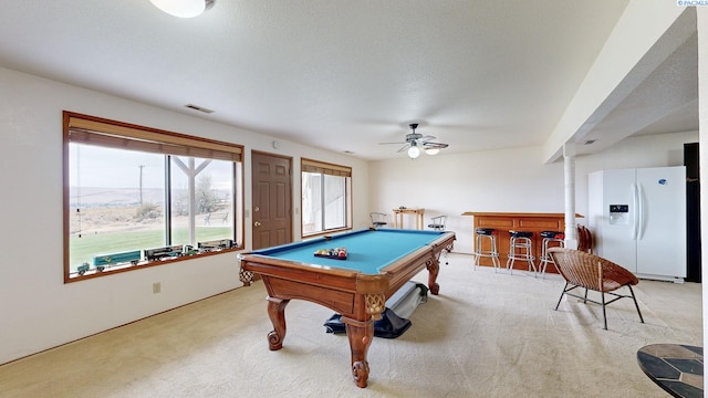 playroom with billiards, ceiling fan, a textured ceiling, light carpet, and indoor bar