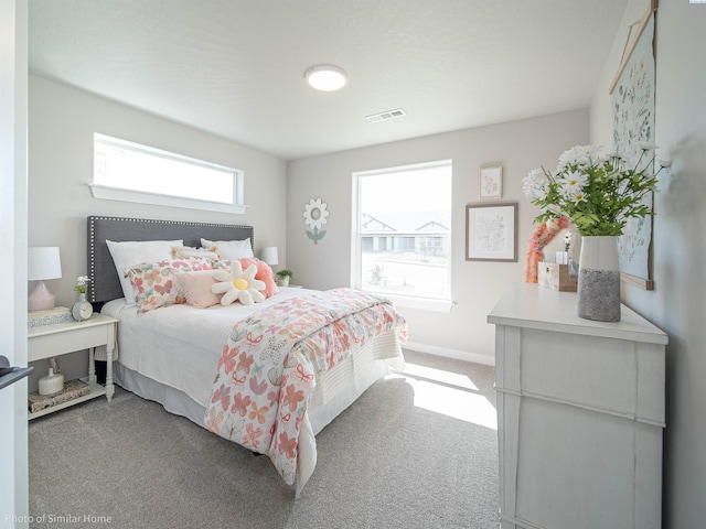 bedroom with carpet floors, visible vents, and baseboards