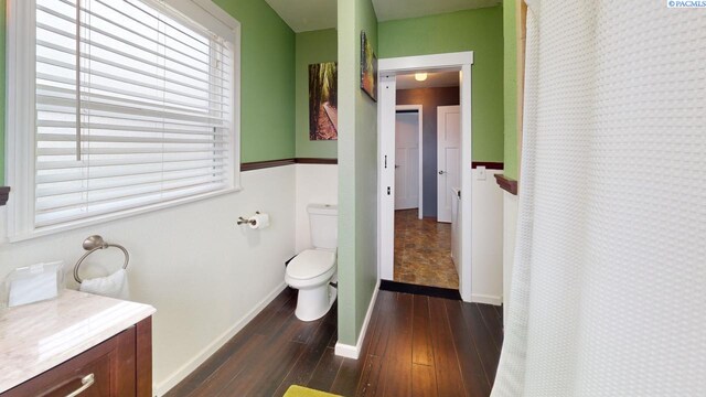 bathroom featuring vanity, hardwood / wood-style floors, and toilet