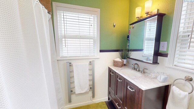 bathroom with vanity and plenty of natural light