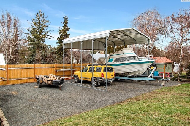 view of car parking with a carport and a lawn