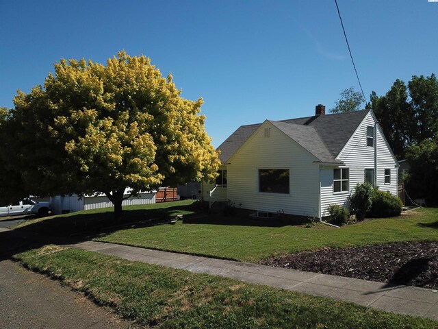 view of side of property with a yard