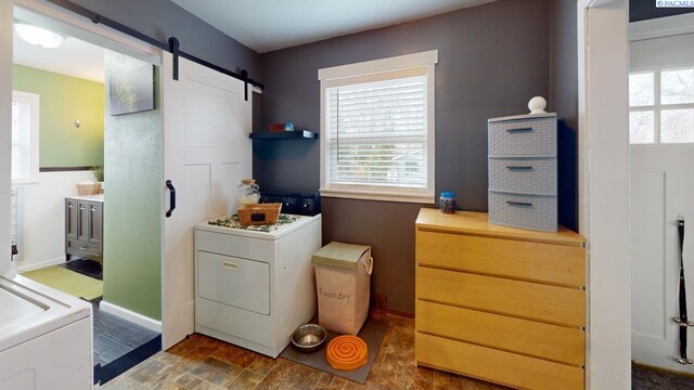 washroom with washer / clothes dryer and a barn door