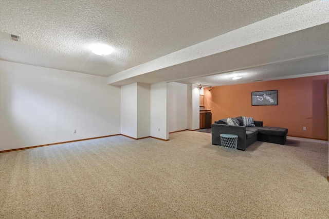 unfurnished living room featuring a textured ceiling, visible vents, light carpet, and baseboards
