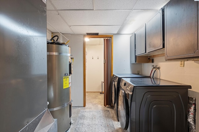 washroom featuring cabinet space, washer and clothes dryer, and secured water heater
