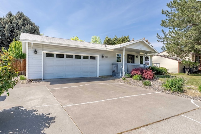 ranch-style house featuring driveway, an attached garage, and covered porch
