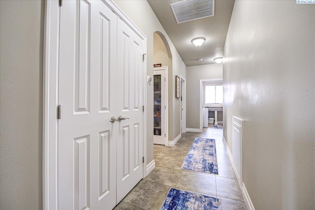 87021 Summit View Dr, Kennewick, WA 99338 - corridor with arched walkways, baseboards, and light tile patterned floors