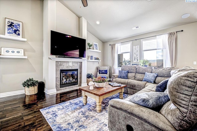 87021 Summit View Dr, Kennewick, WA 99338 - living room featuring vaulted ceiling, dark wood finished floors, a tiled fireplace, and baseboards
