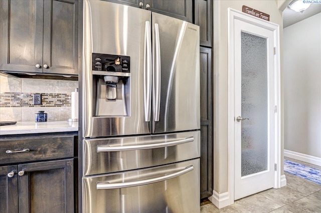 87021 Summit View Dr, Kennewick, WA 99338 - kitchen featuring stainless steel fridge, baseboards, dark brown cabinetry, backsplash, and light countertops