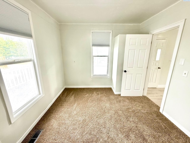 419 W A Ave, Colfax, WA 99111 - carpeted spare room with healthy amount of natural light, baseboards, and crown molding
