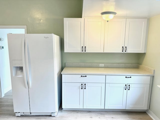 419 W A Ave, Colfax, WA 99111 - kitchen featuring white fridge with ice dispenser, white cabinetry, and light countertops