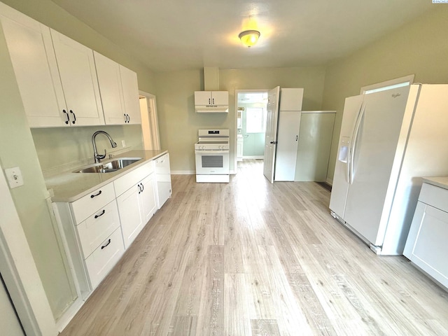 419 W A Ave, Colfax, WA 99111 - kitchen featuring white appliances, a sink, light countertops, light wood-type flooring, and white cabinetry