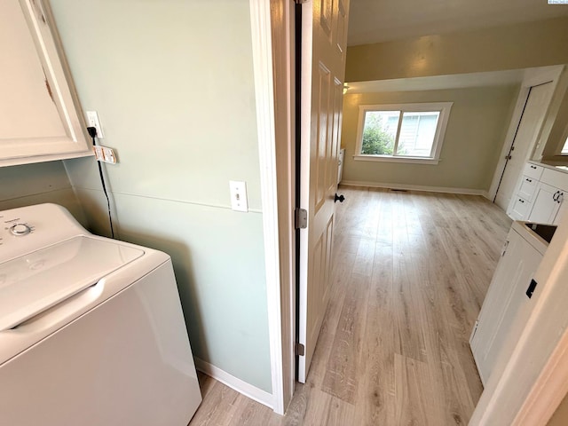 419 W A Ave, Colfax, WA 99111 - washroom with washer / clothes dryer, cabinet space, light wood-type flooring, and baseboards