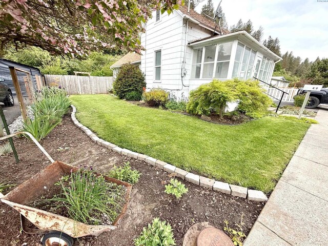 419 W A Ave, Colfax, WA 99111 - view of side of home with a sunroom and a vegetable garden