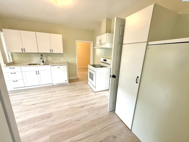 419 W A Ave, Colfax, WA 99111 - kitchen featuring white appliances, a sink, light wood-style floors, under cabinet range hood, and white cabinetry