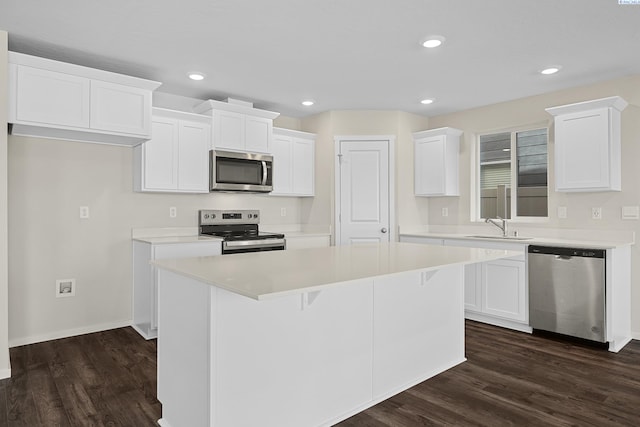 688 S Zeelar St, Kennewick, WA 99336 - kitchen featuring stainless steel appliances, a sink, a center island, dark wood-style flooring, and white cabinetry