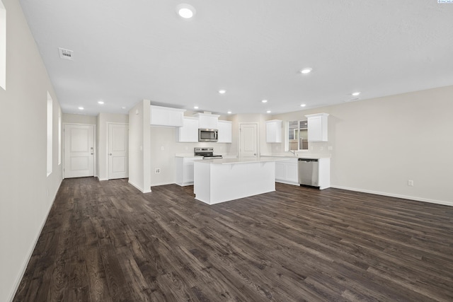 688 S Zeelar St, Kennewick, WA 99336 - kitchen featuring appliances with stainless steel finishes, dark wood finished floors, a center island, white cabinets, and recessed lighting