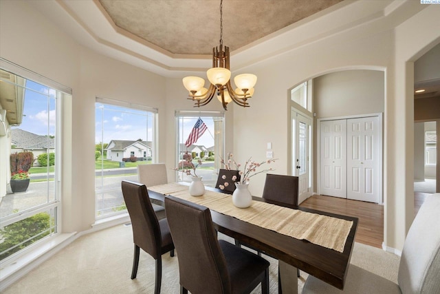 1209 W Canyon Lakes Dr, Kennewick, WA 99337 - dining area with a chandelier, a raised ceiling, and arched walkways