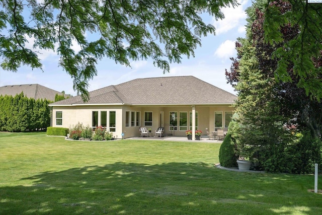 1209 W Canyon Lakes Dr, Kennewick, WA 99337 - back of house featuring a lawn, a patio area, and stucco siding