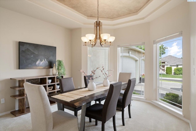 1209 W Canyon Lakes Dr, Kennewick, WA 99337 - dining space with a chandelier, light carpet, and a raised ceiling
