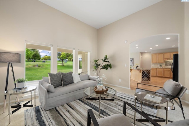 1209 W Canyon Lakes Dr, Kennewick, WA 99337 - living area featuring a high ceiling, light carpet, arched walkways, and recessed lighting